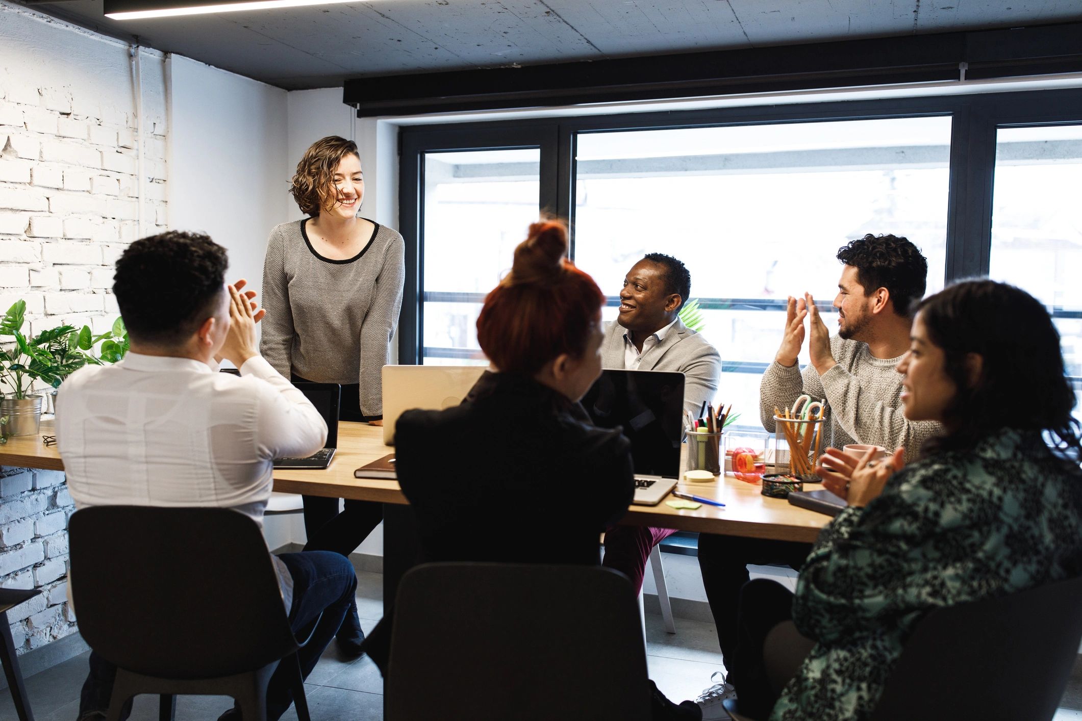 Professional team celebrating progress in a meeting